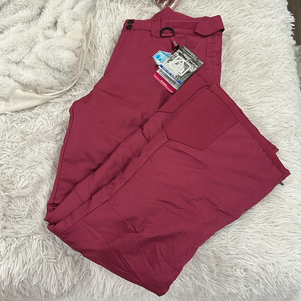 Arctic Quest woman’s ski pant in size Medium in the color raspberry.